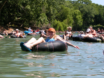 Kaisha tubing on the Horseshoe Loop section of the Guadalupe River with lots of other people!
